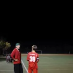 Ulysses Godoy coaching a youth soccer player during an evening match