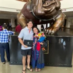 Ulysses Godoy with a graduate at the Fresno State bulldog statue